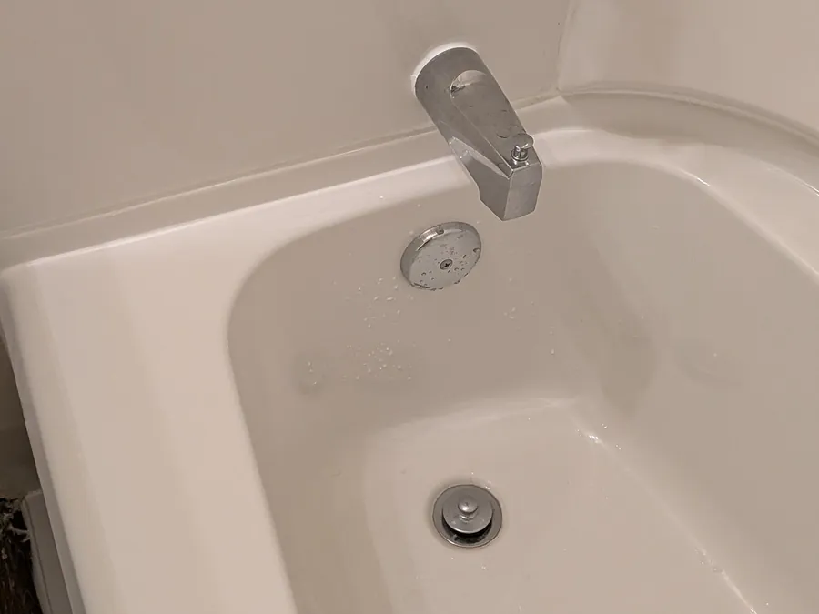 Close detail of a newly set tub and its brushed metal filler