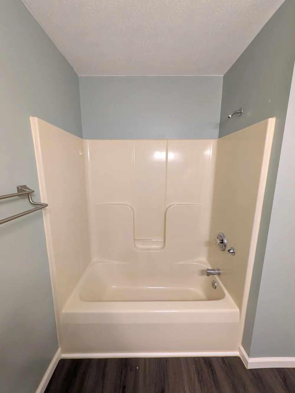 Newly fitted tub and shower alcove in a compact family bathroom