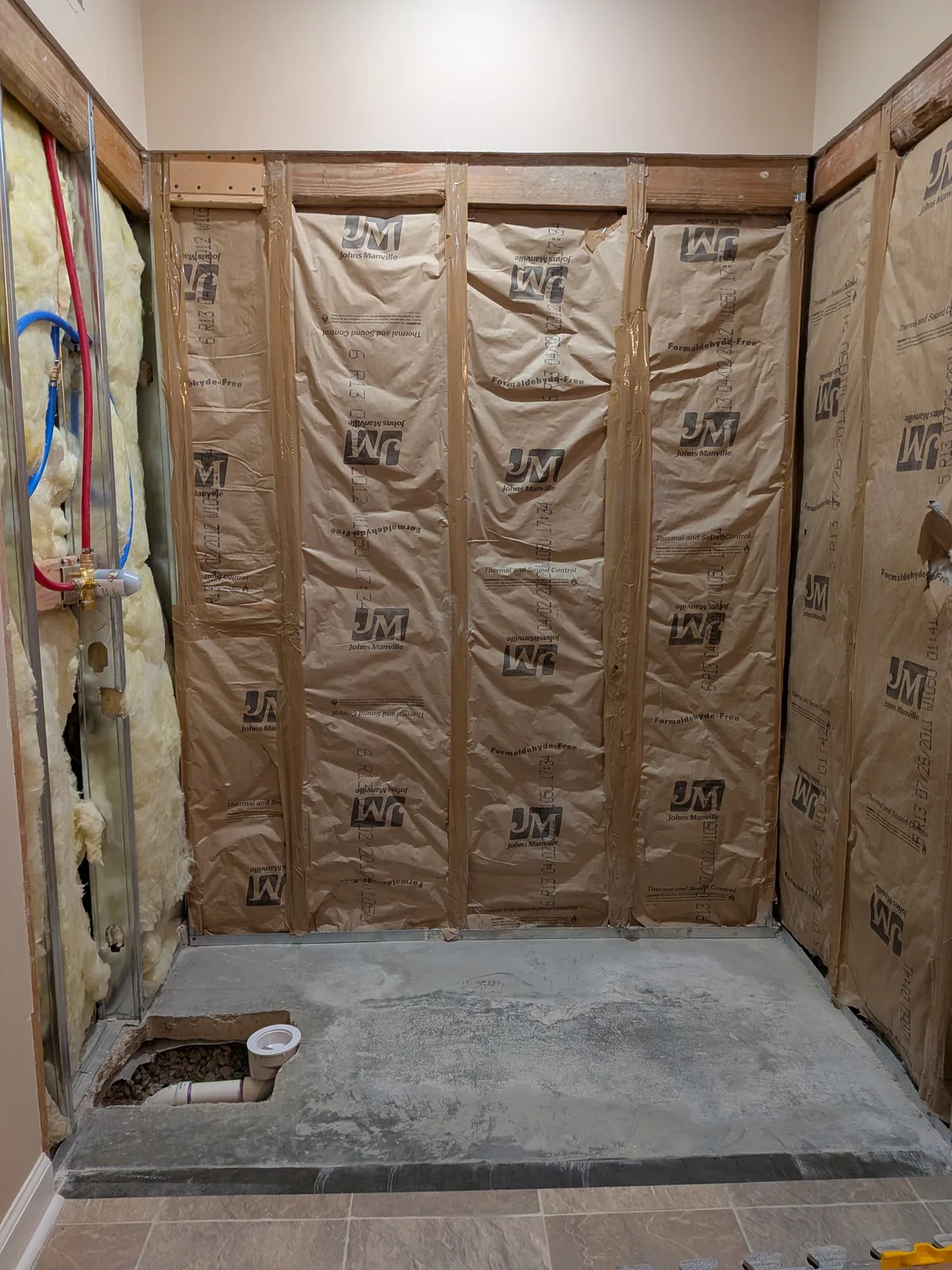 Finished walk-in shower from the bathroom, bronze frame and marble-look panels