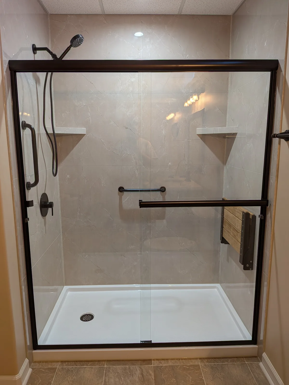 Walk-in shower after the remodel, fold-down seat and grab bars