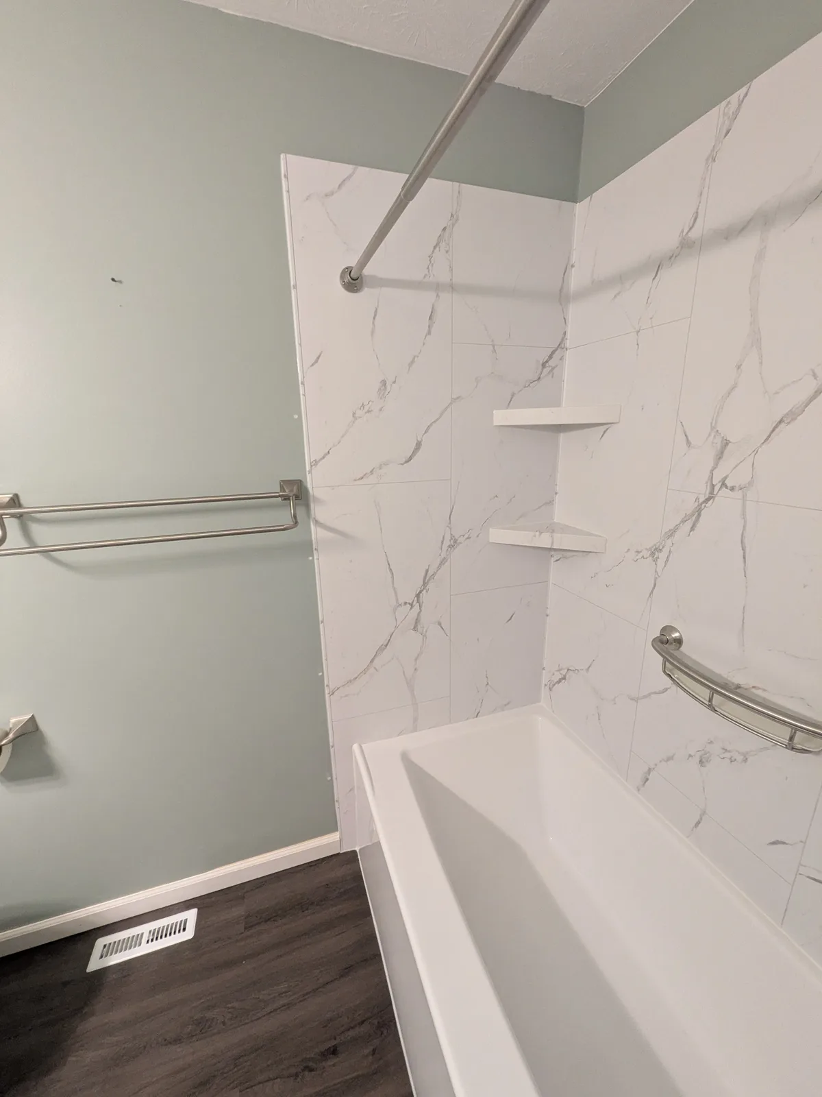 Marble-look tub surround and glass after the remodel