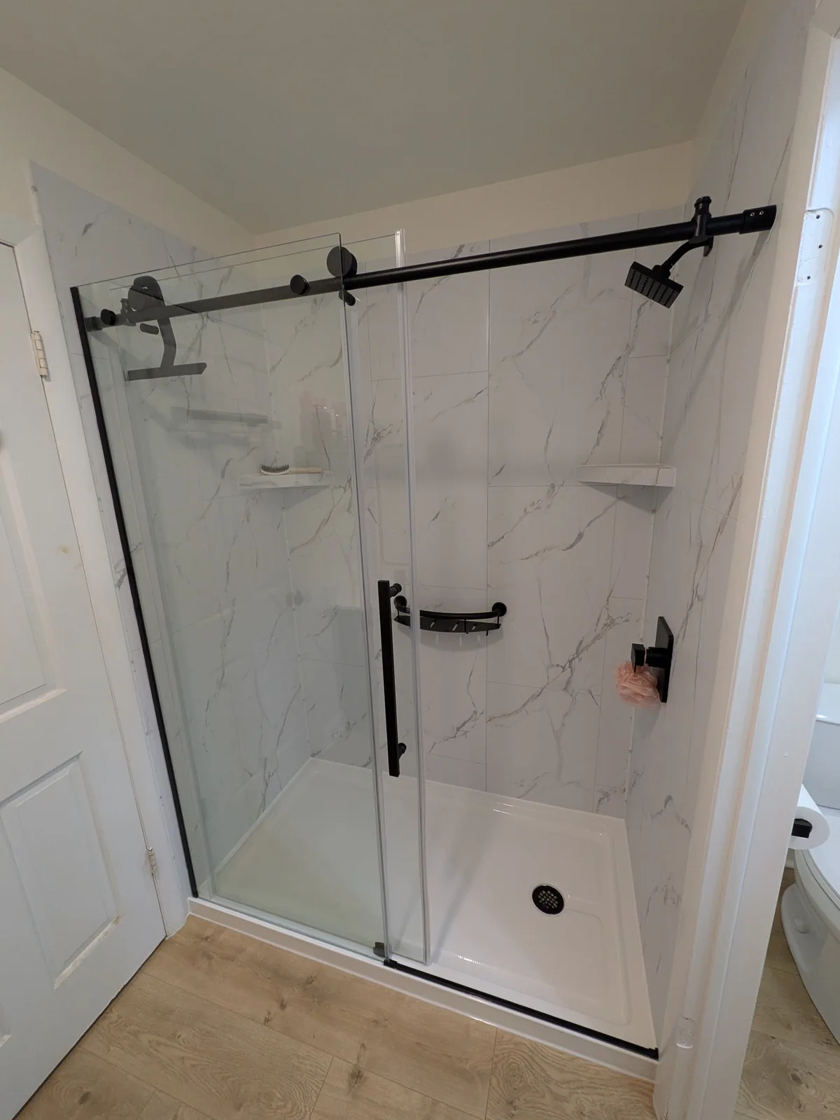 Vanity, mirror and walk-in shower after the remodel