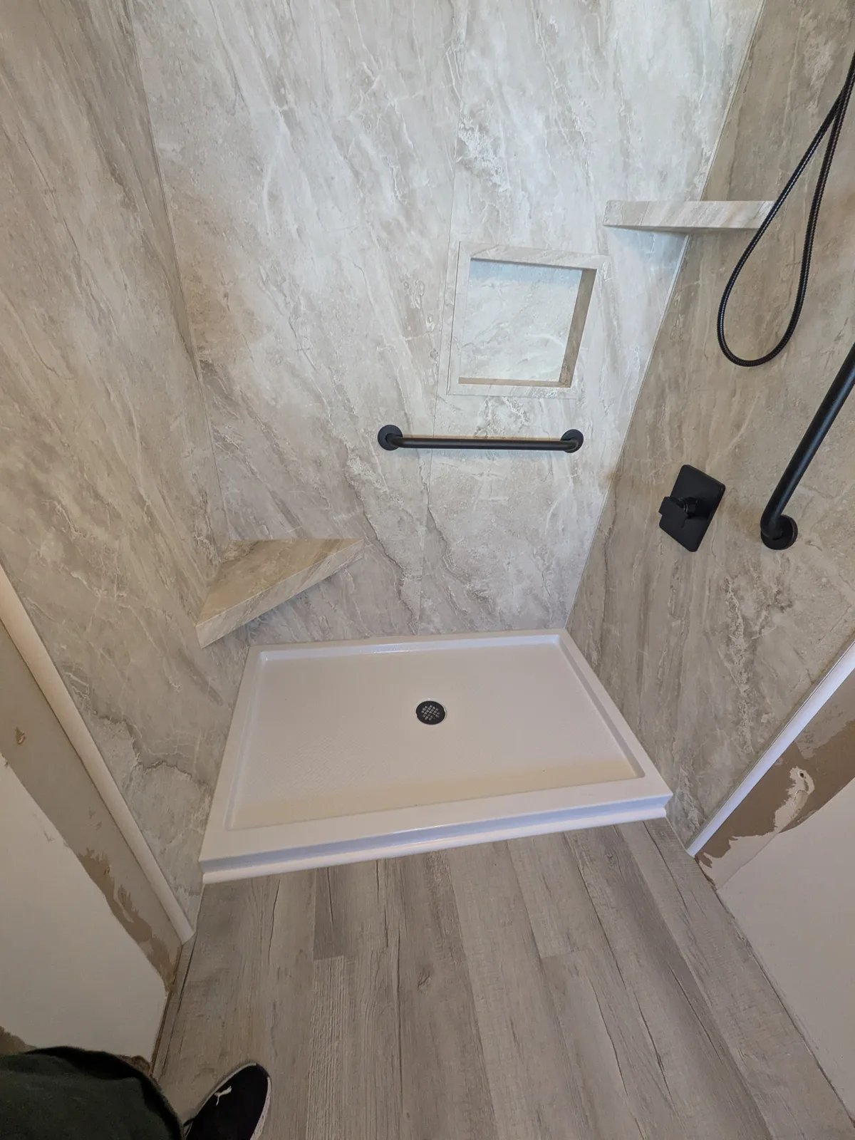 Finished bathroom looking toward the walk-in shower and vanity