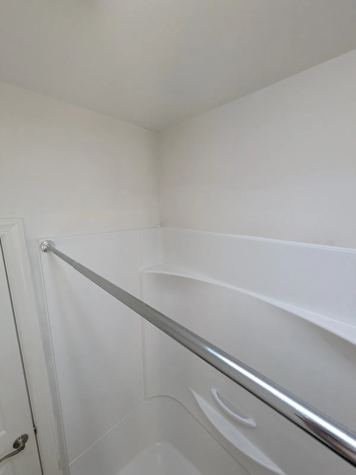 New one-piece tub and shower surround with a grab bar