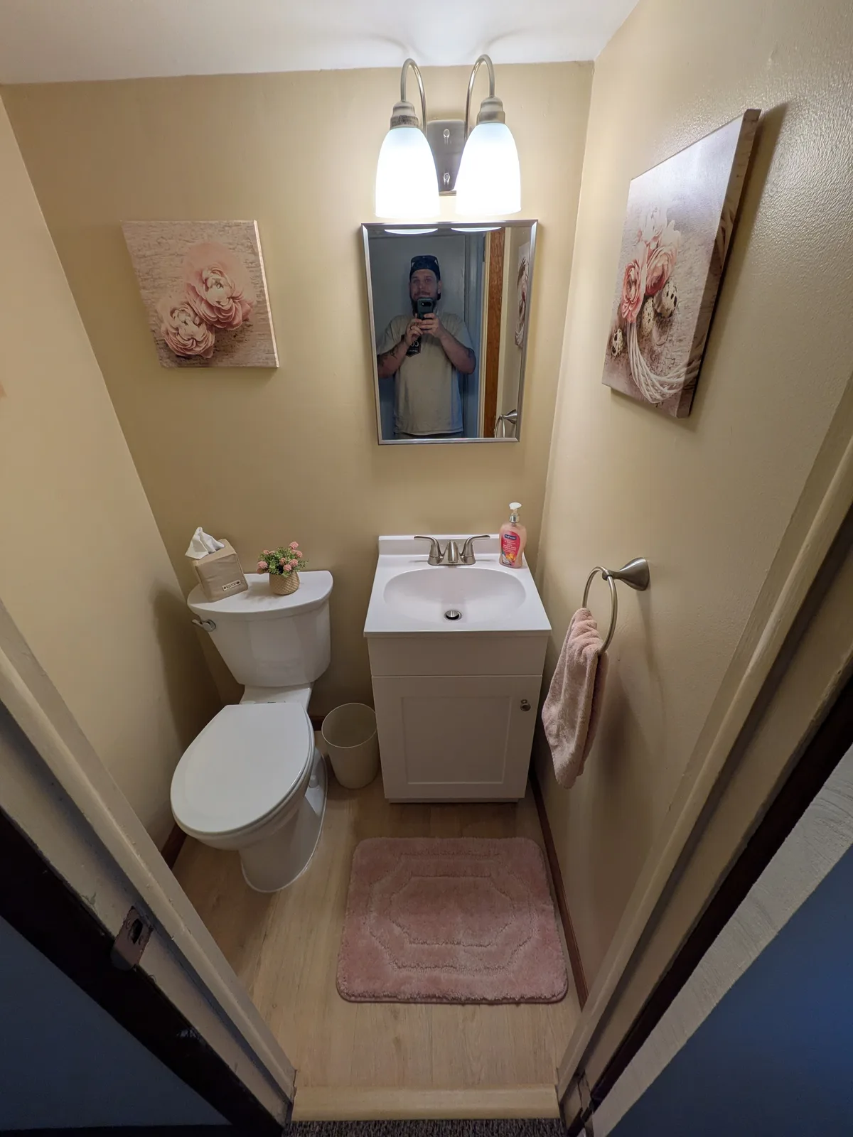 Powder room after the remodel, vanity and wall light